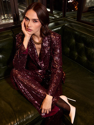 Girl wearing sparkly suit sitting down