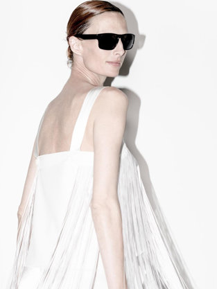 Woman in sunglasses and dress twirling