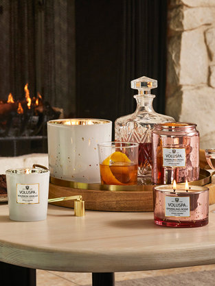 Voluspa candles by fireplace