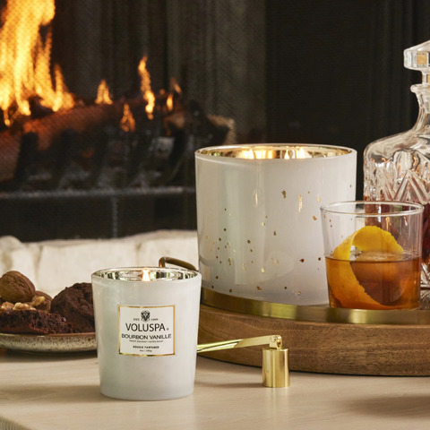 Voluspa candles by fireplace